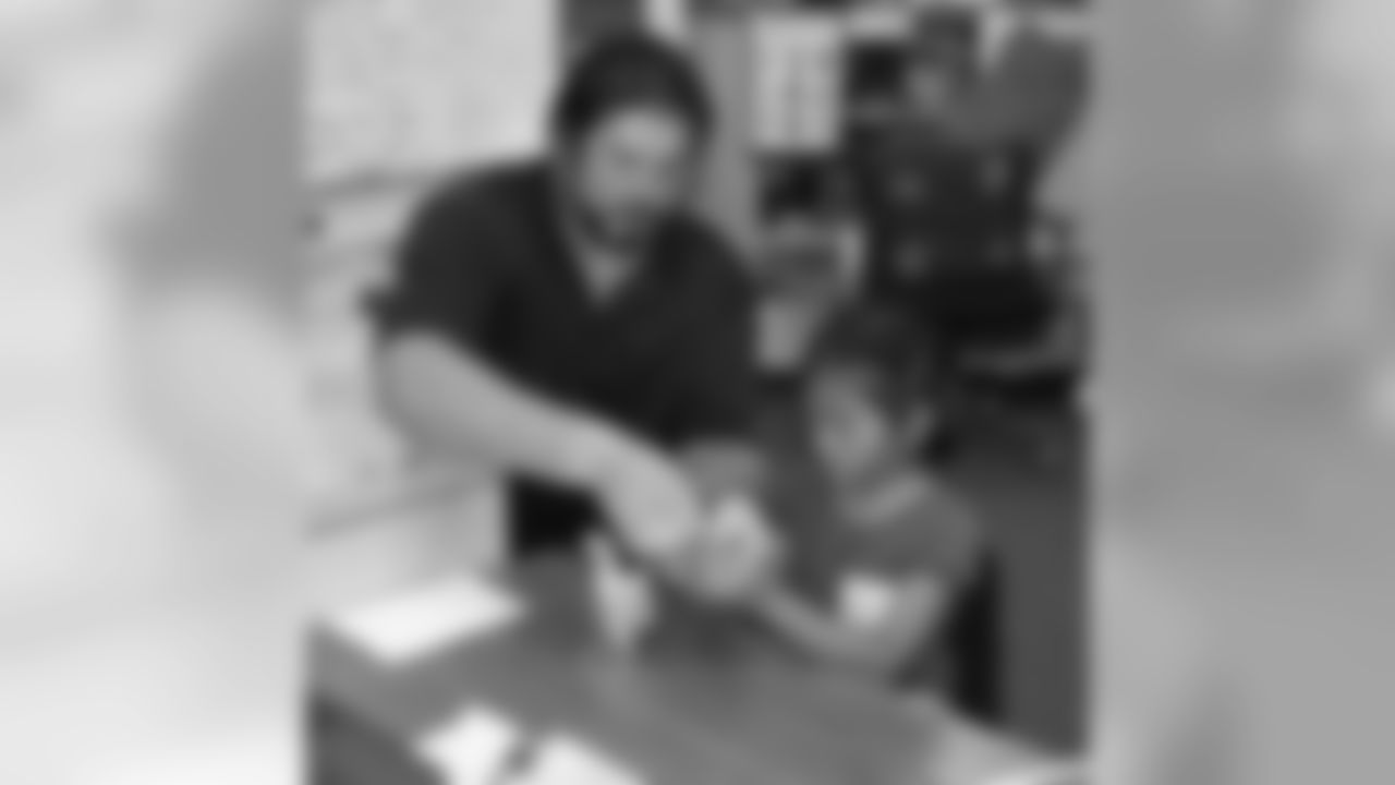 C Eric Heitmann helps a student build a harmonica