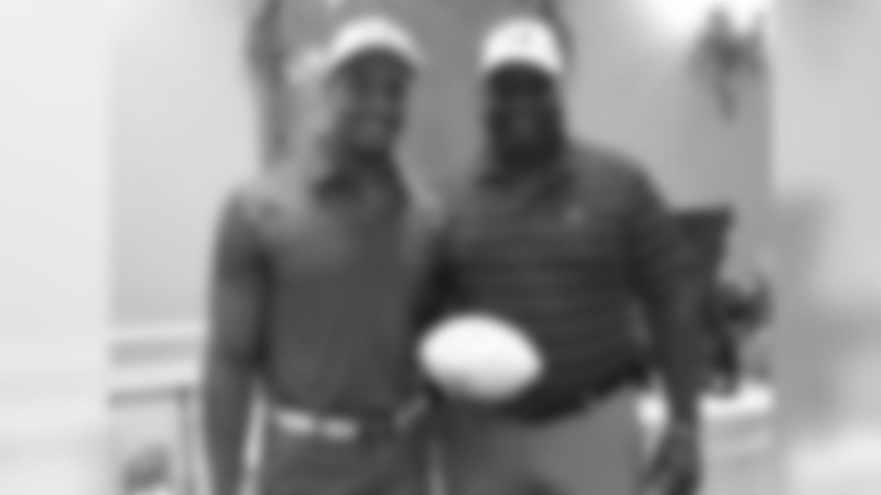 Eric Reid poses for a picture with his dad at the 20th annual Keena Turner Golf Tournament which benefits the Boy's and Girl's Club of Tracy.