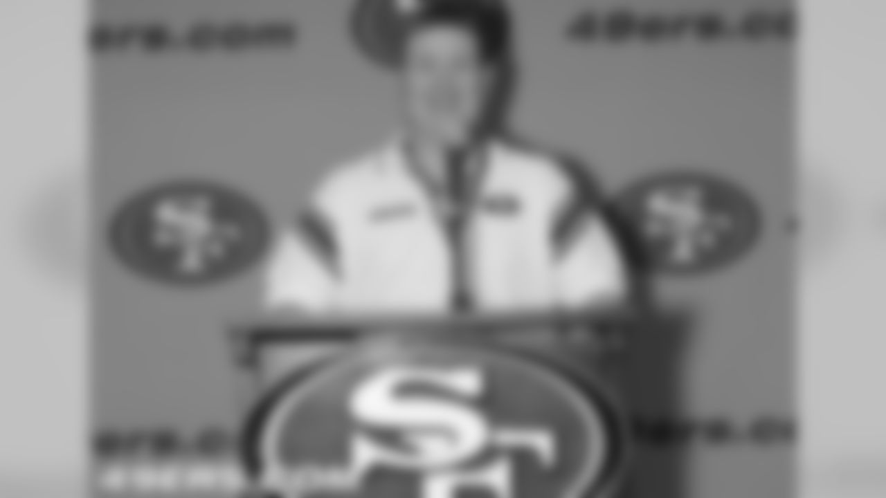 Mark Castanon enjoys the spotlight behind a 49ers podium.