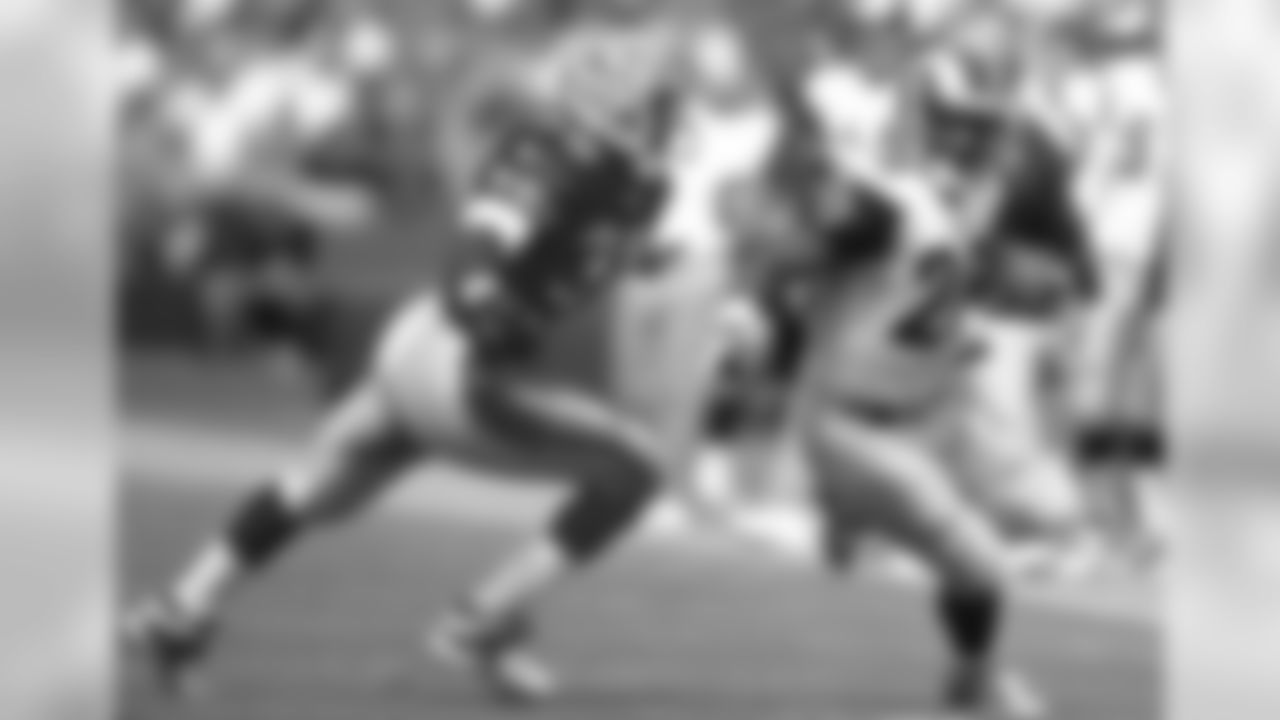 Sept. 23, 2001 -- 49ers safety Lance Schulters and Rams running back Marshall Faulk.