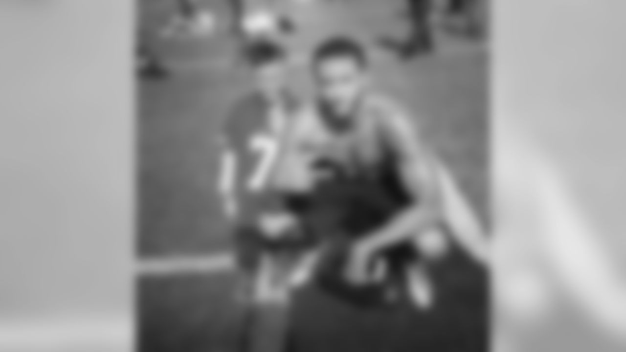 Kaep poses with a young fan during workouts.