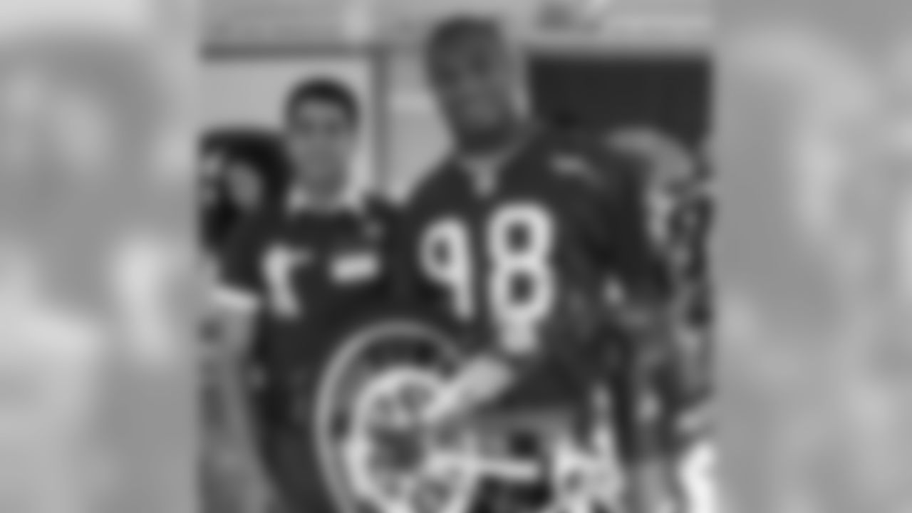 OLB Parys Haralson admires the work he's done as he helps build bikes for k