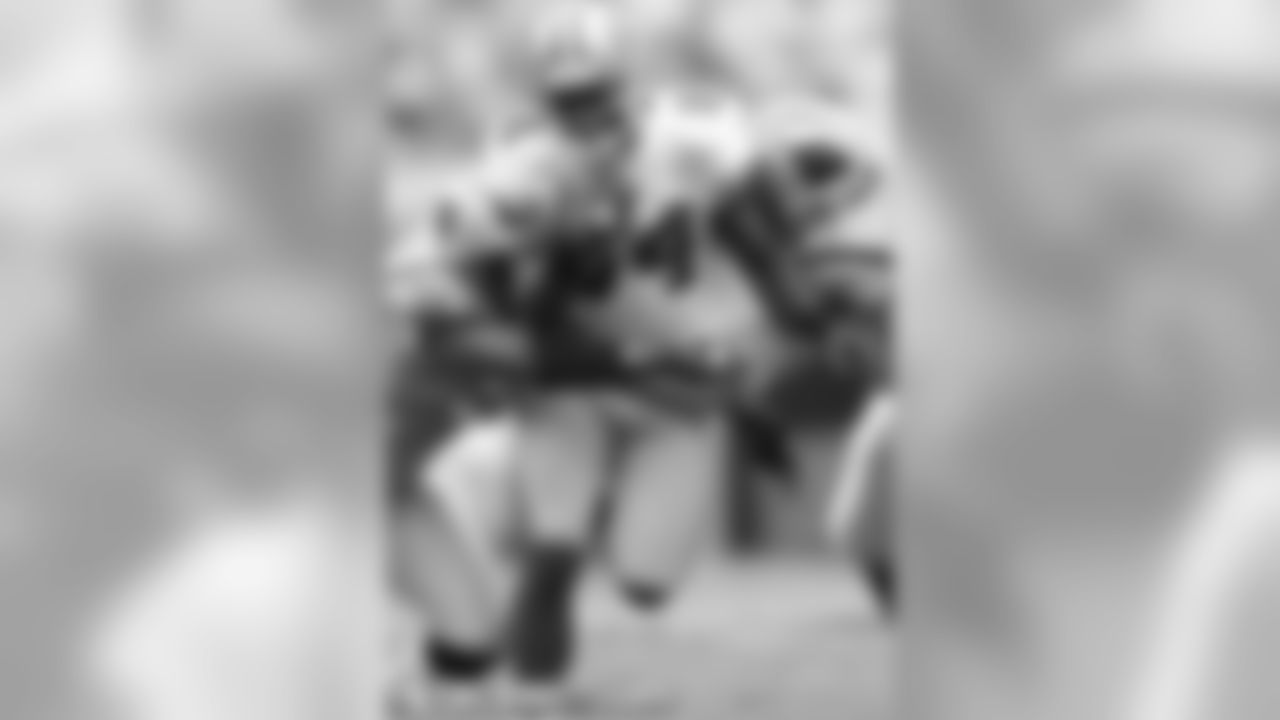 WR Josh Morgan runs between two defenders in Carolina