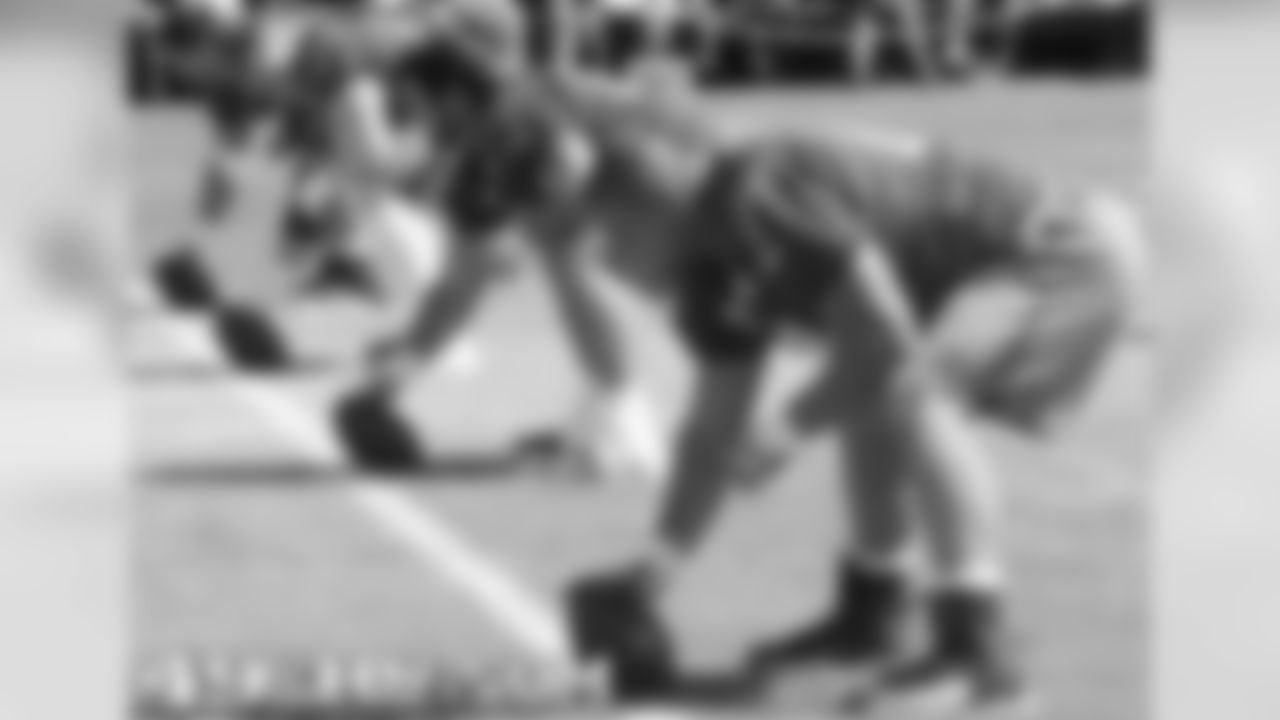 Offensive linemen work on snapping the football