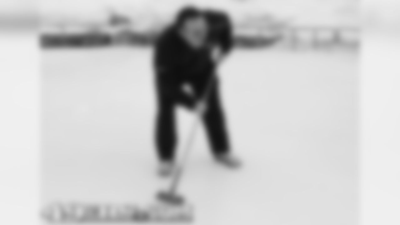 Defensive line coach Jim Tomsula gets in on the curling fun