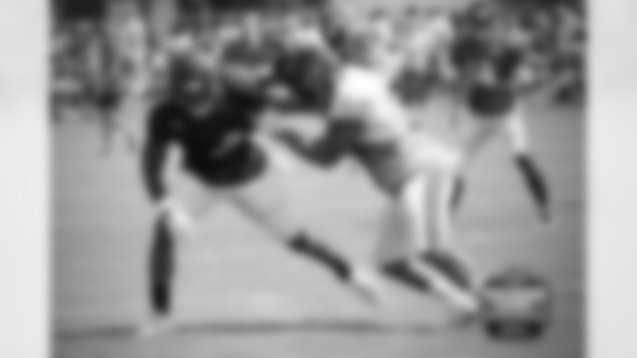RB Senorise Perry (32) and LB John Timu (53).
