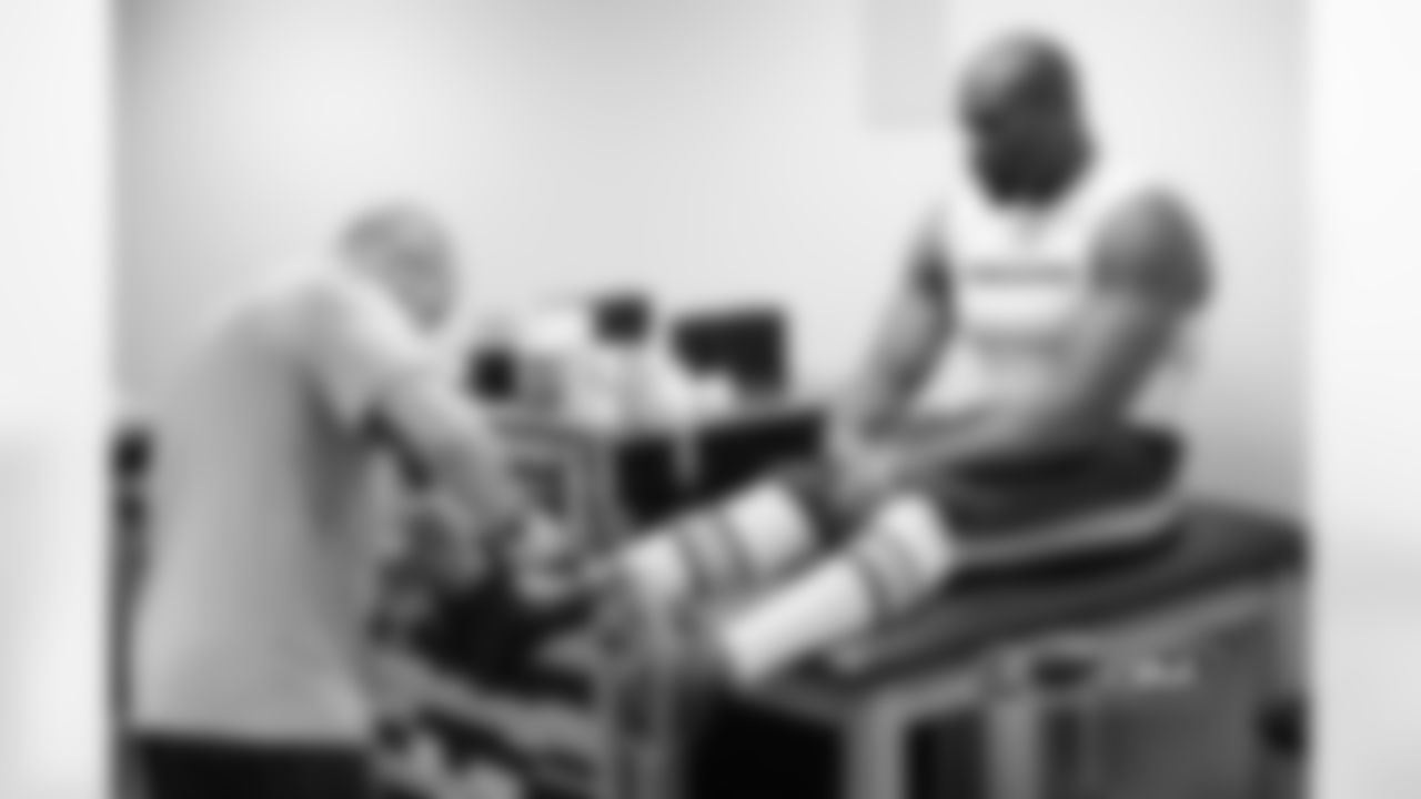 DE Israel Idonije has his ankle taped by a Bears athletic trainer before the game.