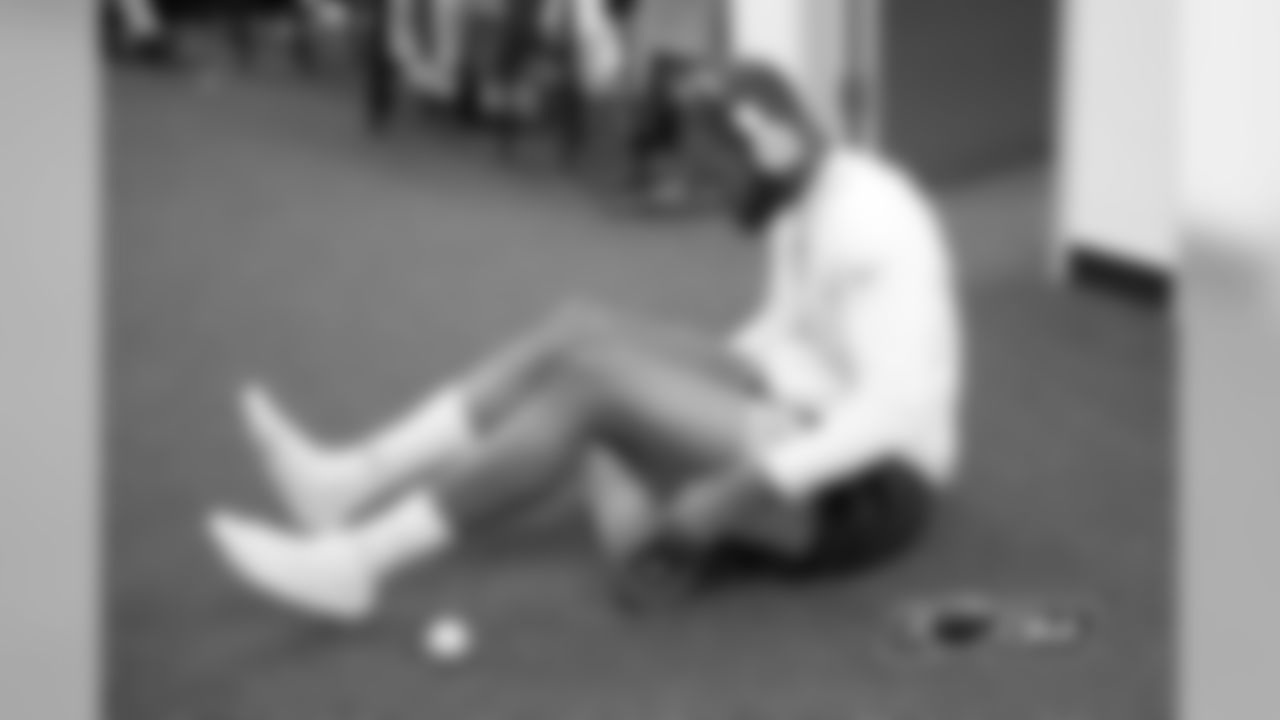 Tight end Martellus Bennett goes through some stretching exercises in the locker room.