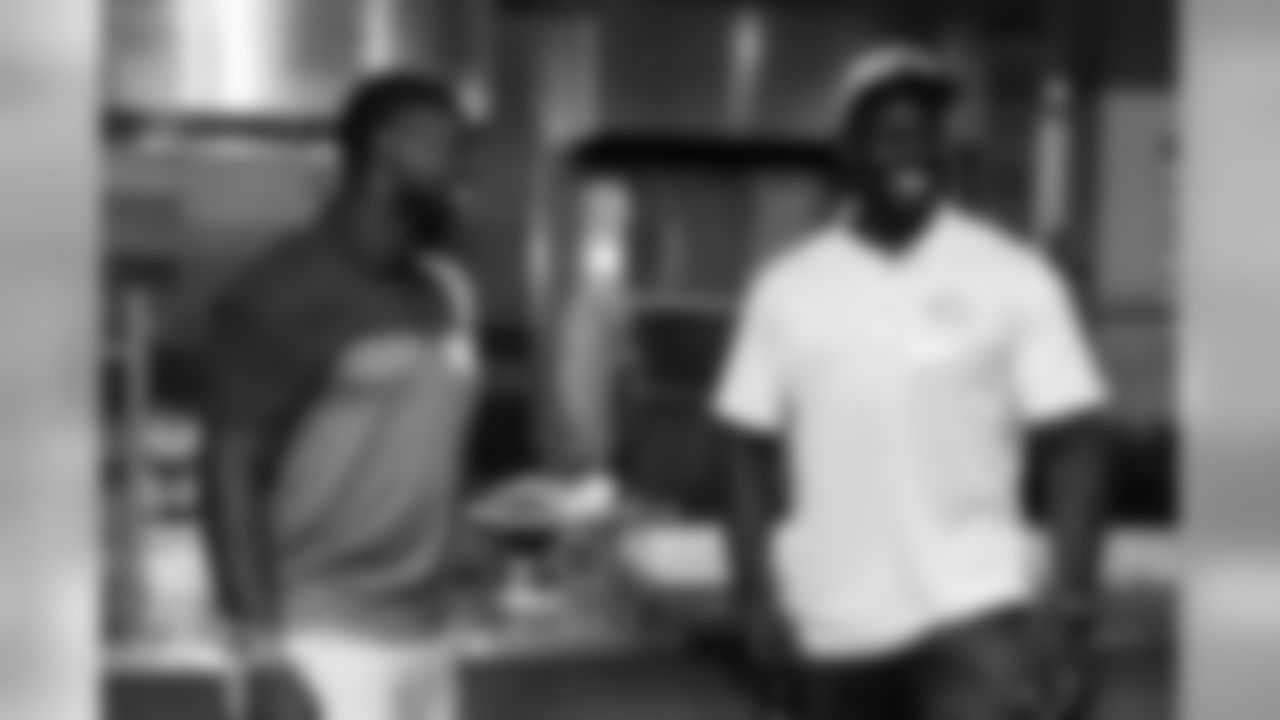 LB Roquan Smith laughs with former Bears player Alex Brown.