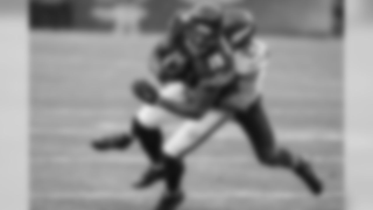Chicago Bears WR Brandon Marshall wrapped up by Vikings CB Josh Robinson.