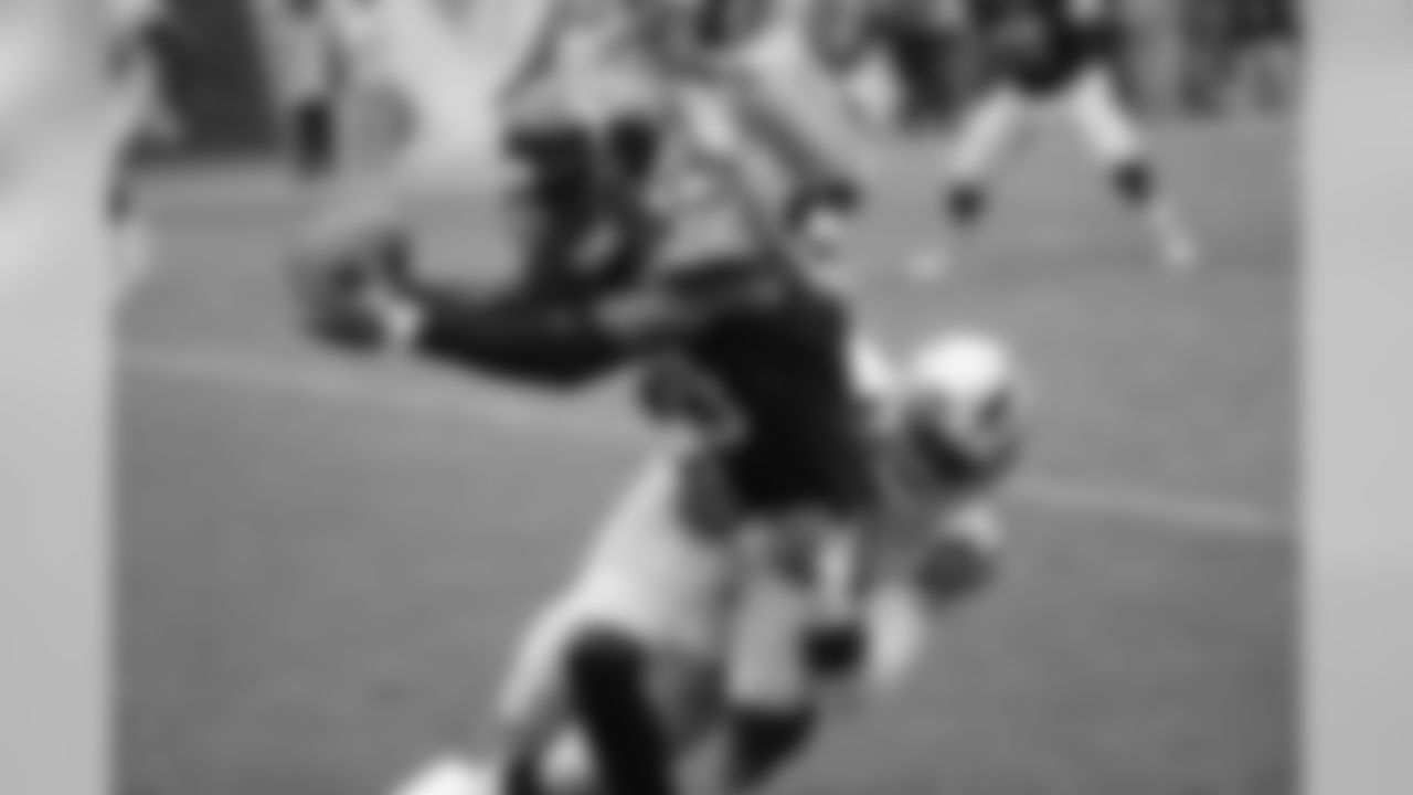 Chicago Bears wide receiver Eddie Royal stretches his arms after making a catch as Oakland Raiders cornerback D.J. Hayden tackles him