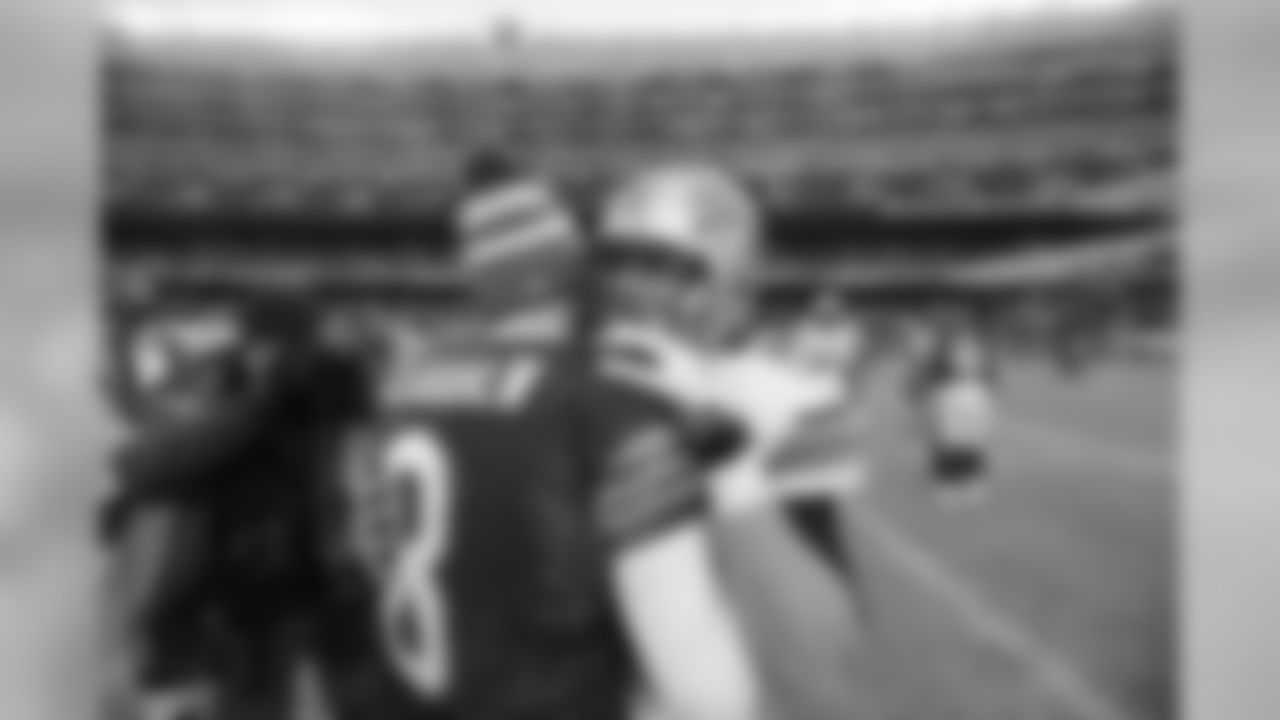 Bears QB Jimmy Clausen talks with Lions QB Matthew Stafford after the game