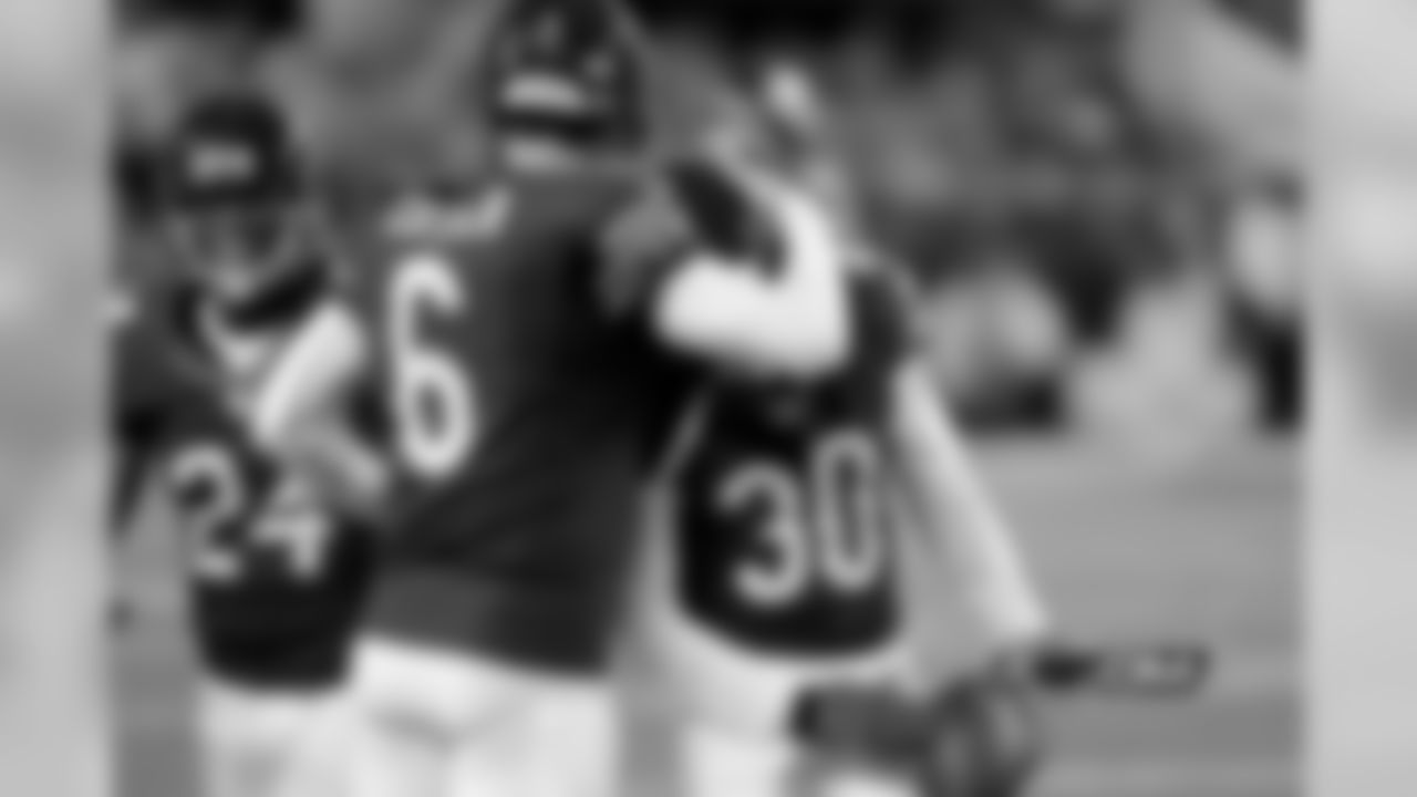 Bears CB D.J. Moore is congratulated by QB Jay Cutler and CB Kelvin Hayden after intercepting Tony Romo in the fourth quarter.