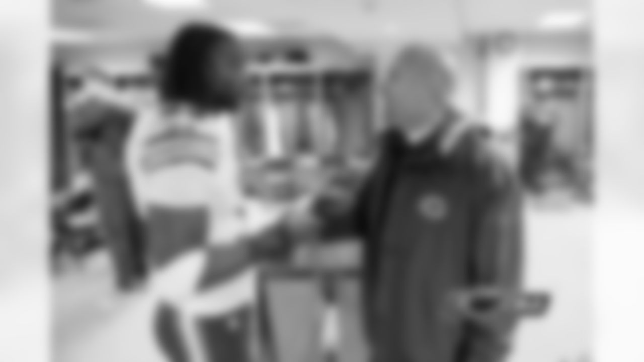 Defensive backs coach Jon Hoke congratulates Charles Tillman on a productive performance against the Packers.