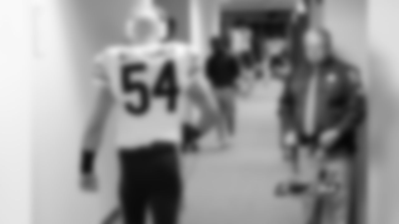 54 Brian Urlacher walks through the visitor's locker room before the game.