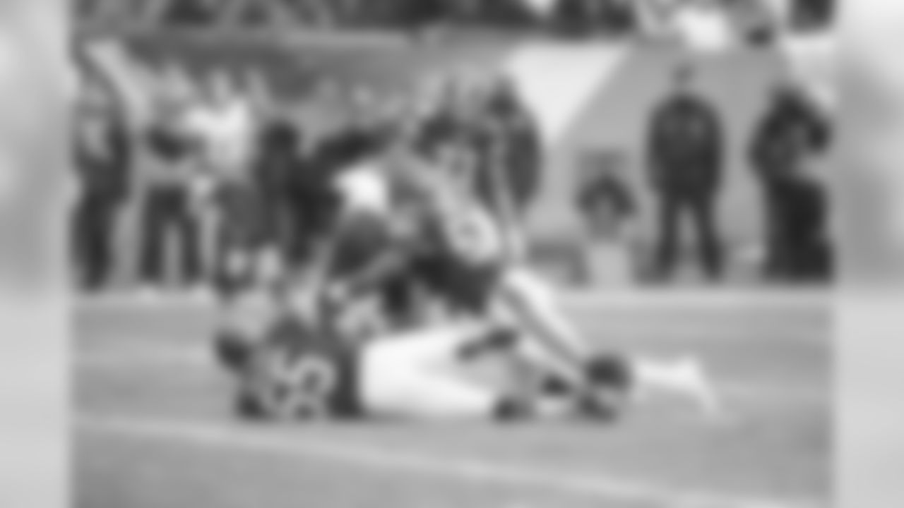 LB Lance Briggs and LB Jon Bostic make a tackle.