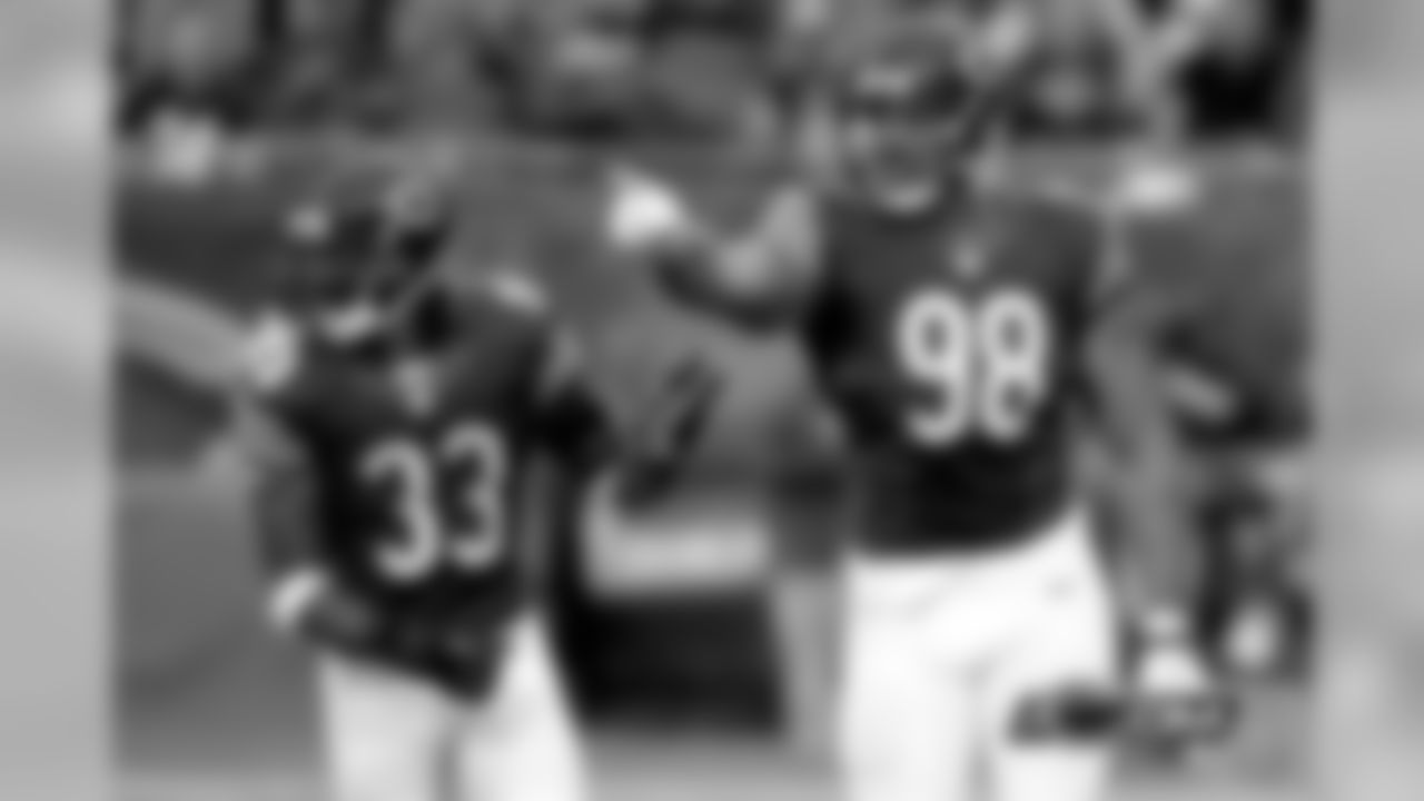 98 Corey Wootton celebrates with #33 Charles Tillman after bursting inside to sack Chargers QB Phillip Rivers for a nine-yard loss.