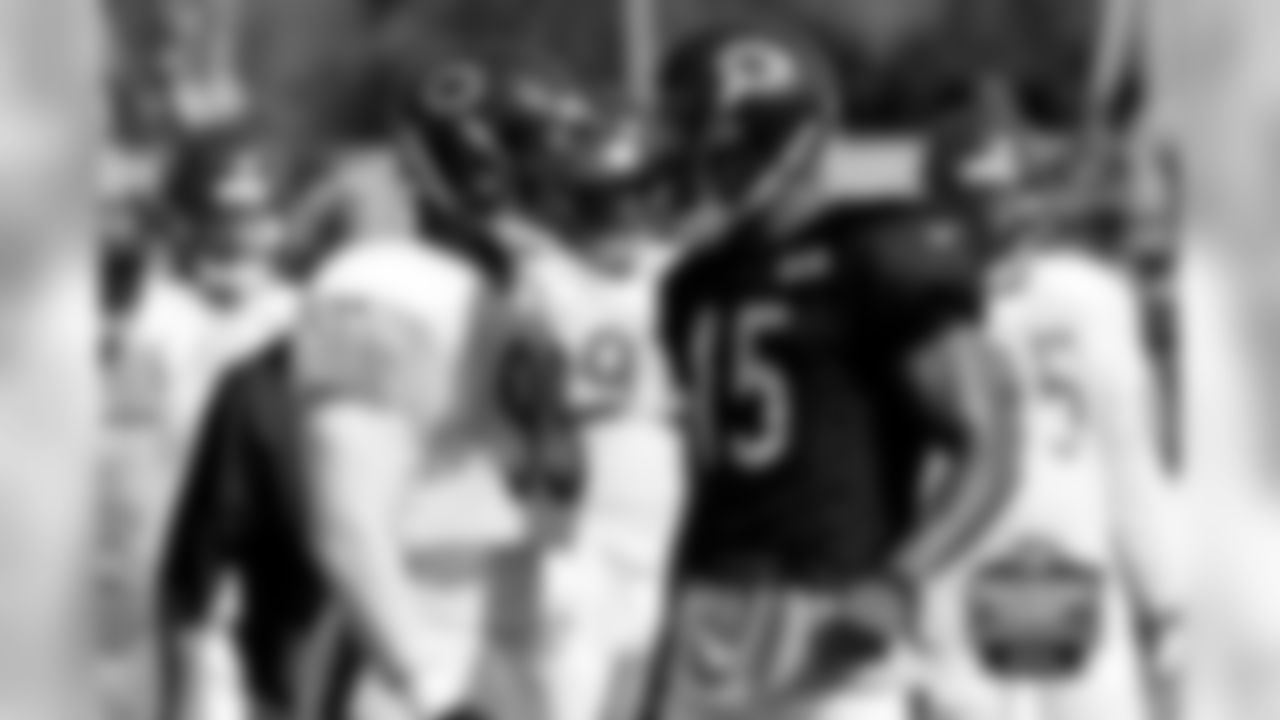 DE Lamarr Houston jaws on the sidelines with WR Brandon Marshall.