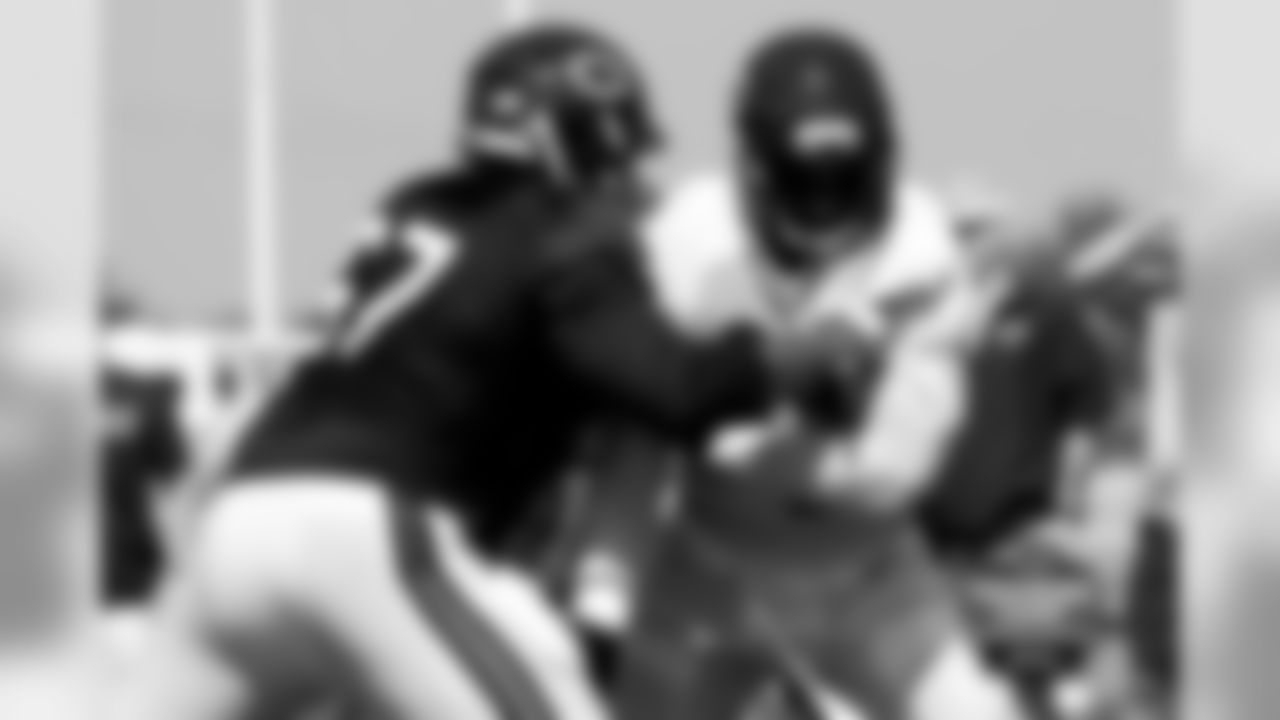 RT Jordan Mills goes head-to-head with DE Lamarr Houston in line drills