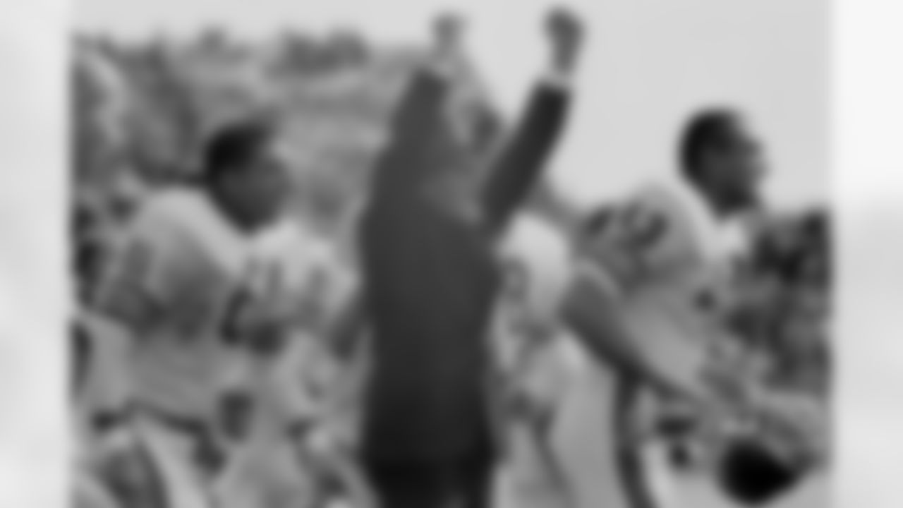 Chicago Bears head coach George Halas and linebacker Bill George celebrate the last second of the game as their team defeated the Green Bay Packers, 10-3, at City Stadium.