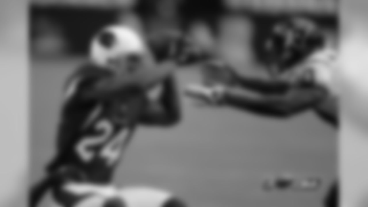 Arizona Cardinals' Adrian Wilson (24) falls as Houston Texans' Andre Johnson defends during the first quarter of an NFL preseason football game.