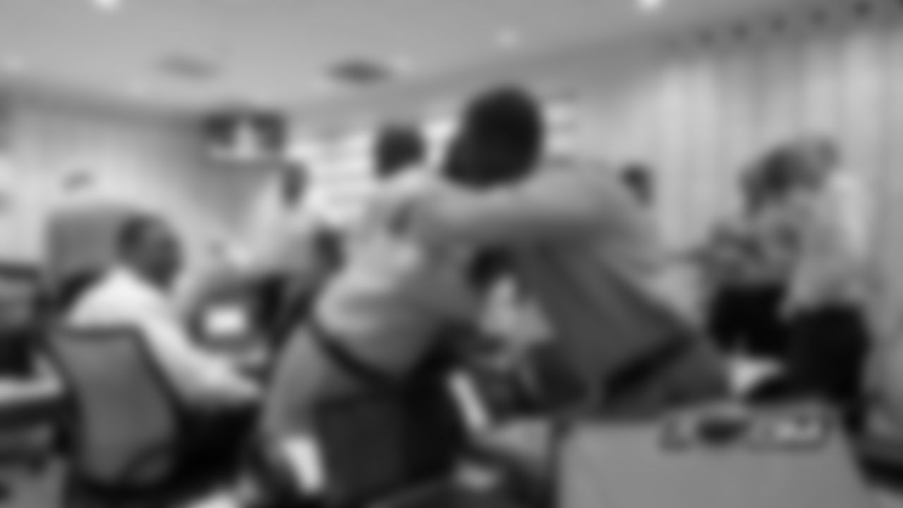 Associate Director of Pro Personnel Dwayne Joseph congratulates area scout Jay Muraco after the Bears selected CB Kyle Fuller with the 14th pick in the NFL Draft.
