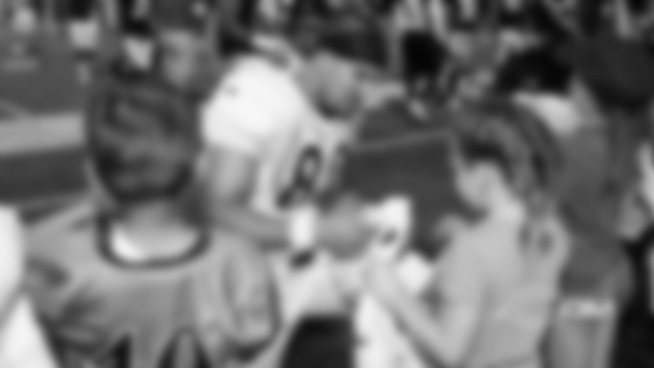 Burton signs autographs for fans following training camp practice at Olivet Nazarene University in August.