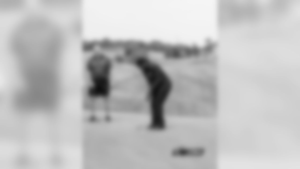 Tom Andrews waits while Adrian Peterson putts
