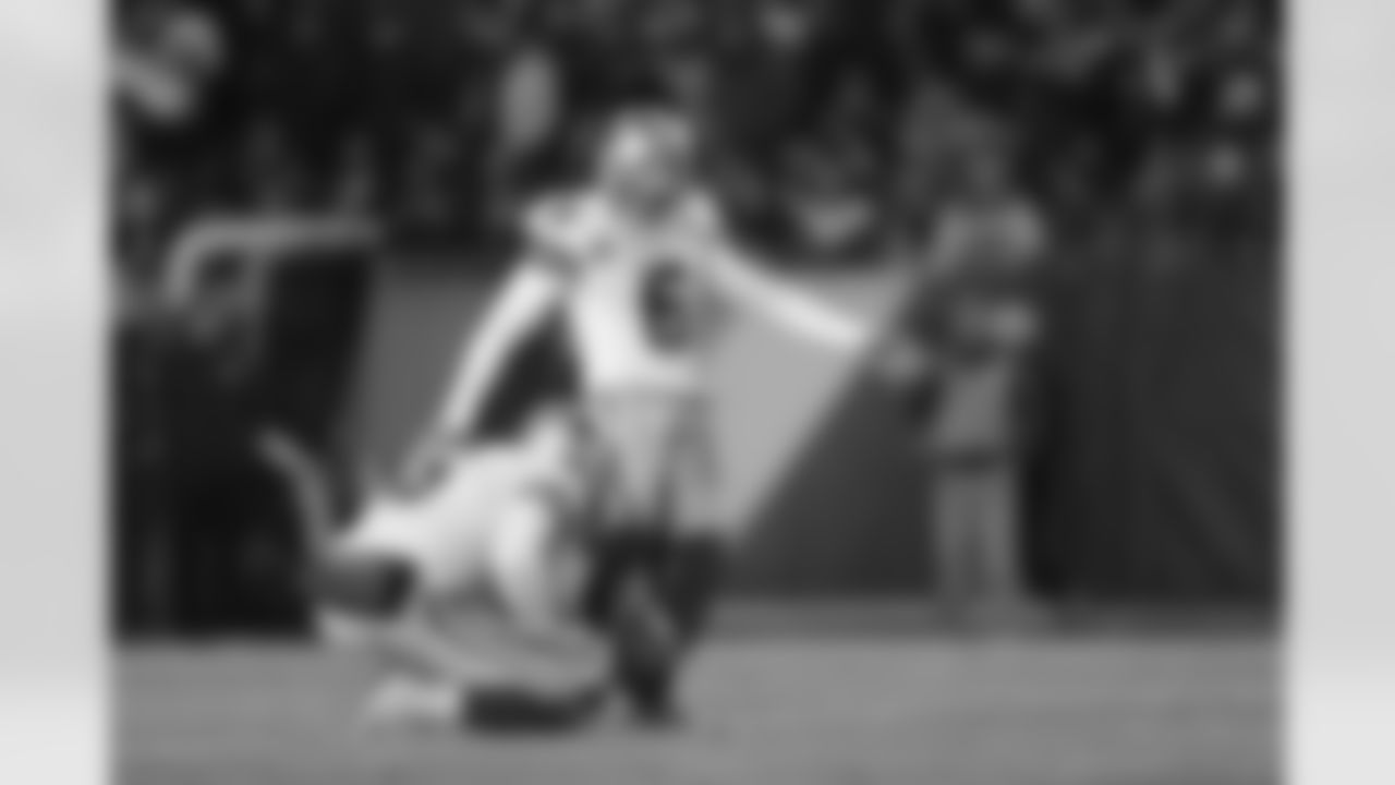 Cowboys P Chris Jones kicks an extra point