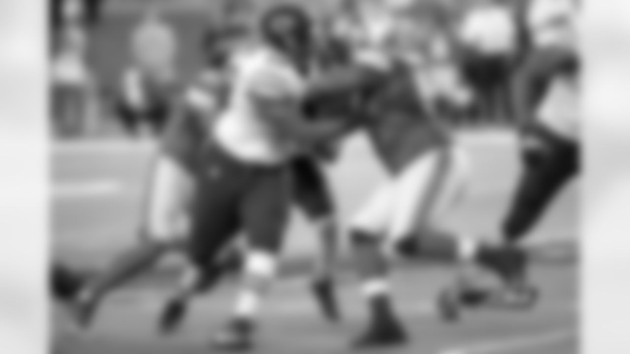 Rookie James Brown clears space through the Lions defense for Bears RB Kahlil Bell.