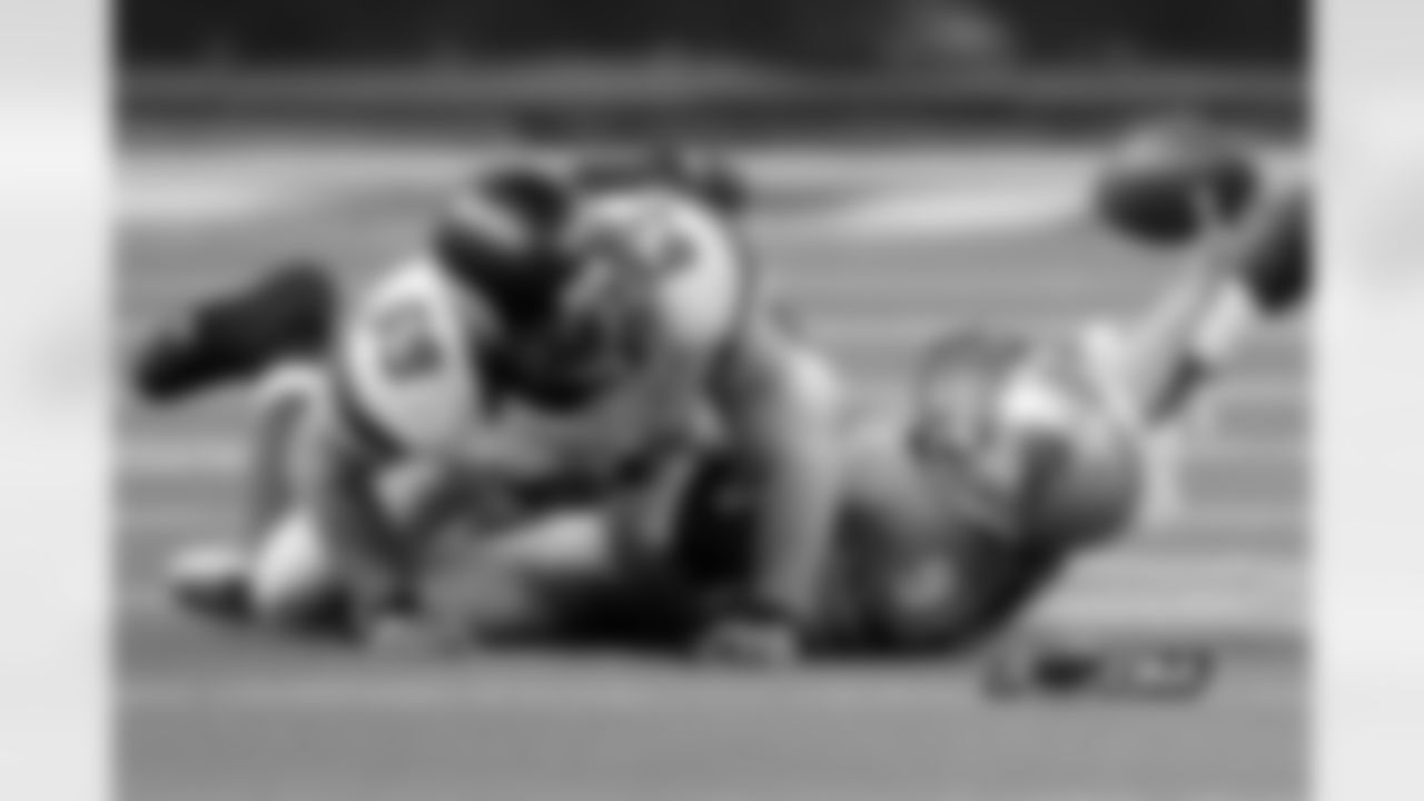 Detroit Lions quarterback Matthew Stafford (9) lies under Minnesota Vikings defensive end Jared Allen (69).