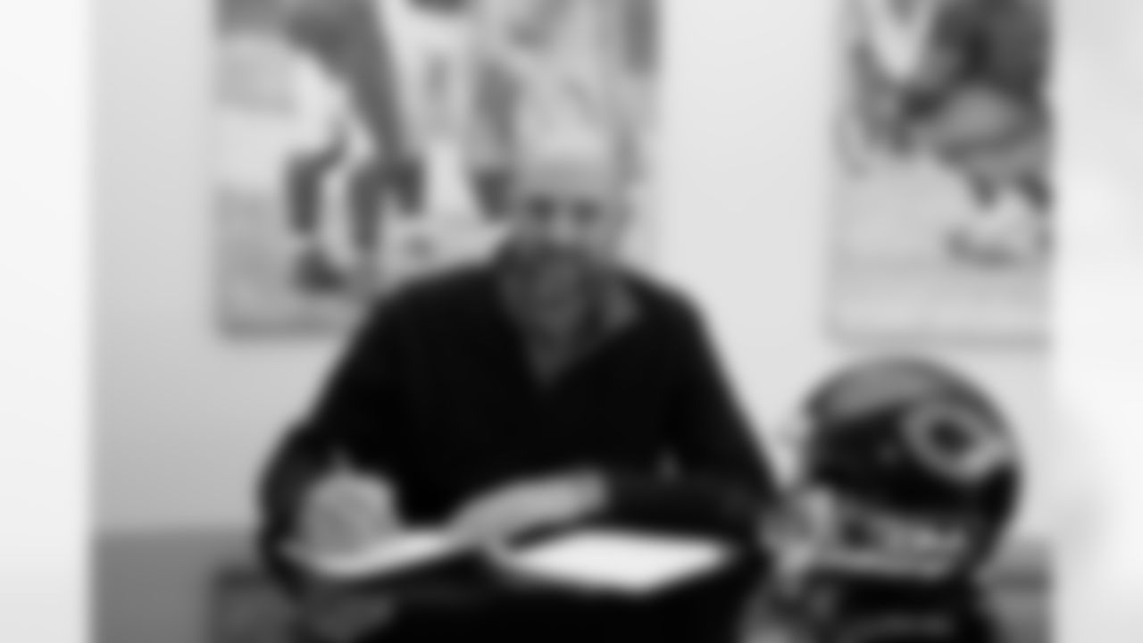Coach Nagy signs his contract with the Bears.
