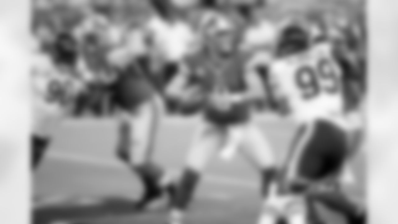 90 Julius Peppers and #99 Shea McClellin battle their way into the Lions' backfield.