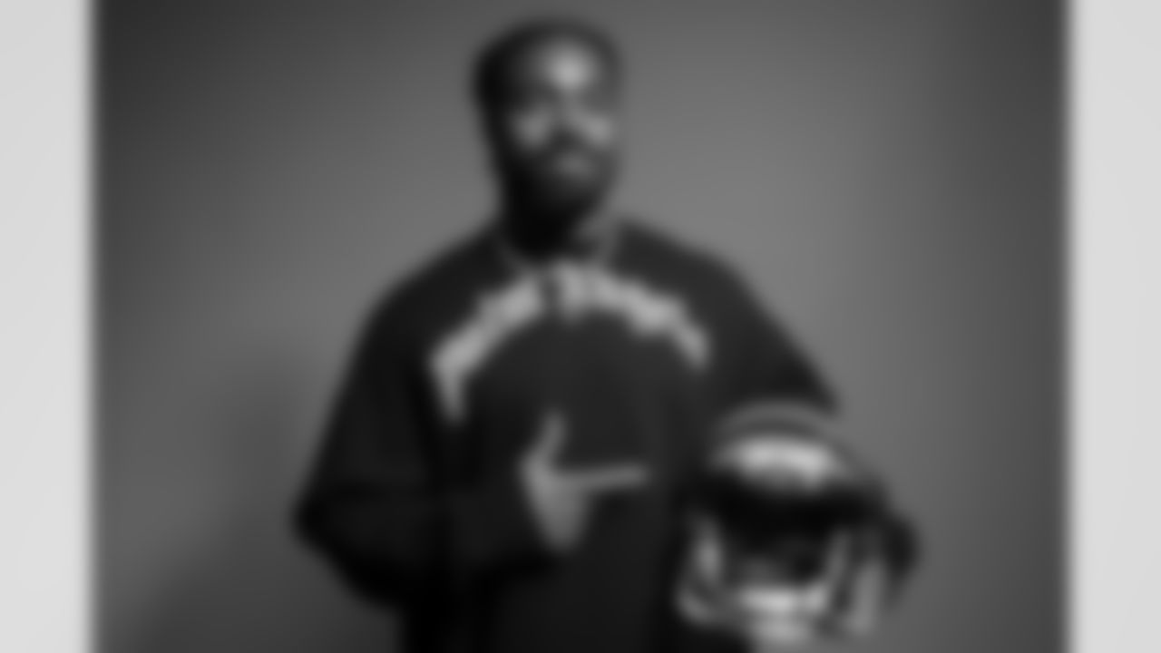 Newly signed Bengals S Nick Scott points to a Bengals helmet during his media shoot on March 20th, 2023.