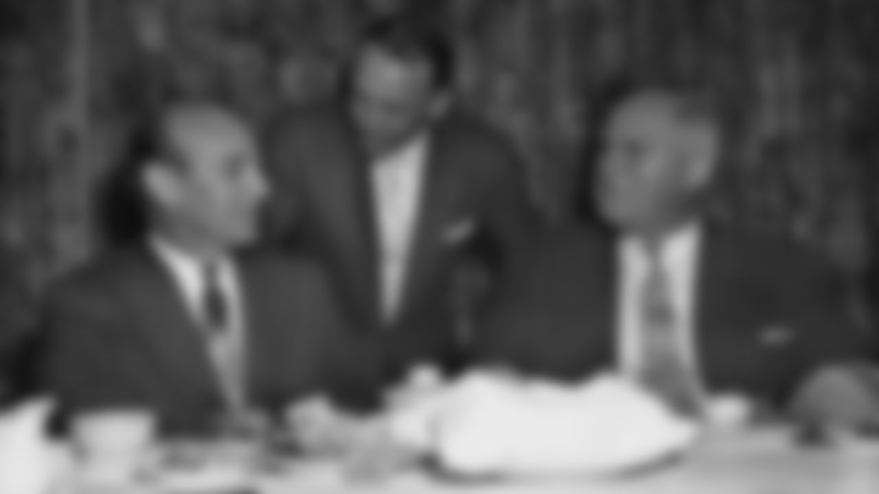Football coaches Paul Brown, left, and Steve Owen, right, ponder over a question asked by Eddie Stanky, center, manager of the St. Louis Cardinals, at a banquet held in Mobile Ala., Jan. 8, 1954, for members of the North and South football teams. The teams will face each other in the Senior Bowl game in Mobile on Jan. 9. (AP Photo)