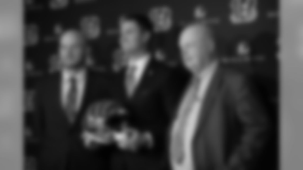 Bengals head coach Zac Taylor, along with Duke Tobin (left) and Team President Mike Brown (right) pose for photos at Taylor's first press conference.