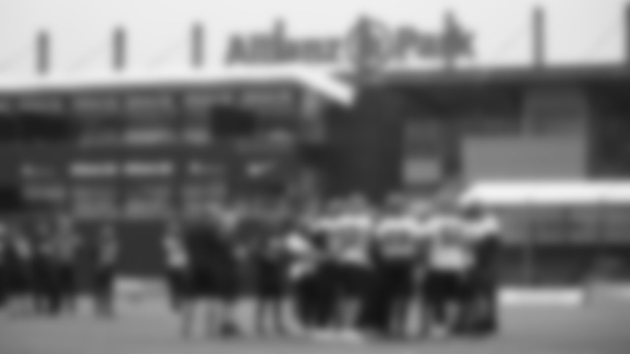 The offense huddles during practice at Allianz Park.