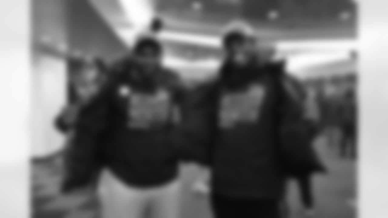 OLB Owen Carney (left) and DE Jeff Gunter pose for a photo as the team celebrates winning the AFC North in the Bengals locker room at Paycor Stadium on Sunday, January 8 2023.