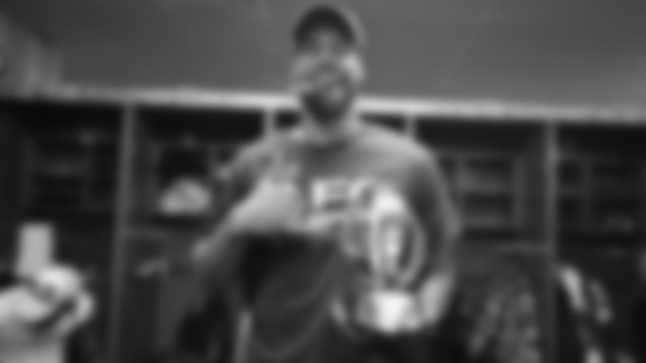 C.J. Uzomah celebrates with the AFC Championship trophy.