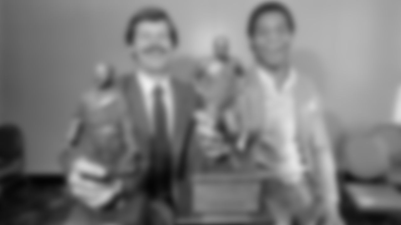Cincinnati Bengals quarterback Ken Anderson, left, and USC running back Marcus Allen holds their Bert Bell Awards they received from the Maxwell Club, Feb. 11, 1982, in Philadelphia. The Maxwell Club named Anderson the top pro football player and Allen the top player in college. (AP Photo/Rusty Kennedy)