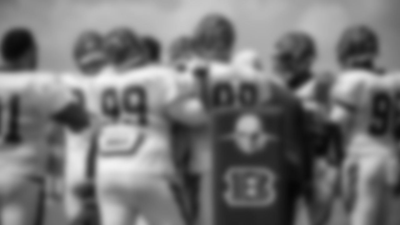 The defensive line huddles before starting a drill at practice.