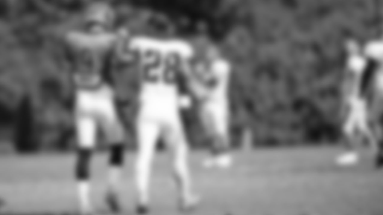 Quarterback Joe Burrow and running back Joe Mixon walk off the field after the team scrimmage.