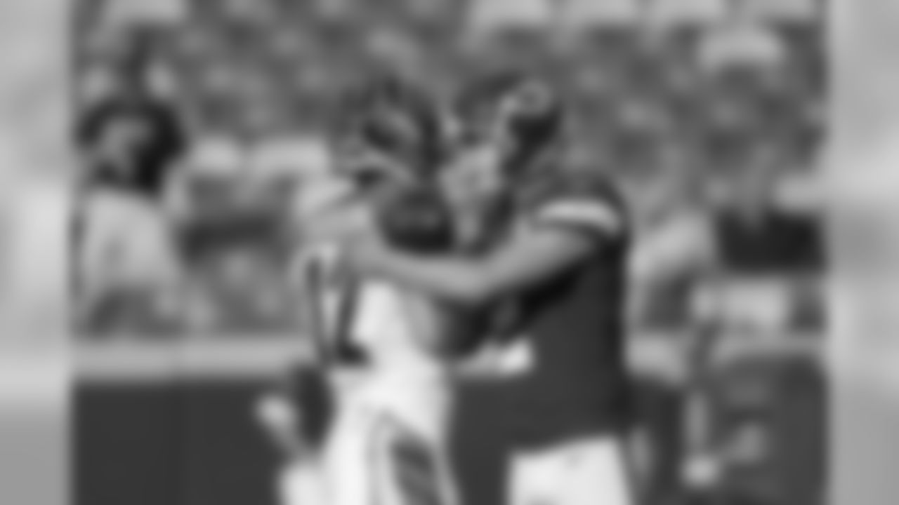 Cincinnati Bengals wide receiver Alex Erickson (12) and Kansas City Chiefs punter Dustin Colquitt (2) visit before an NFL preseason football game in Kansas City, Mo., Saturday, Aug. 10, 2019. (AP Photo/Colin E. Braley)