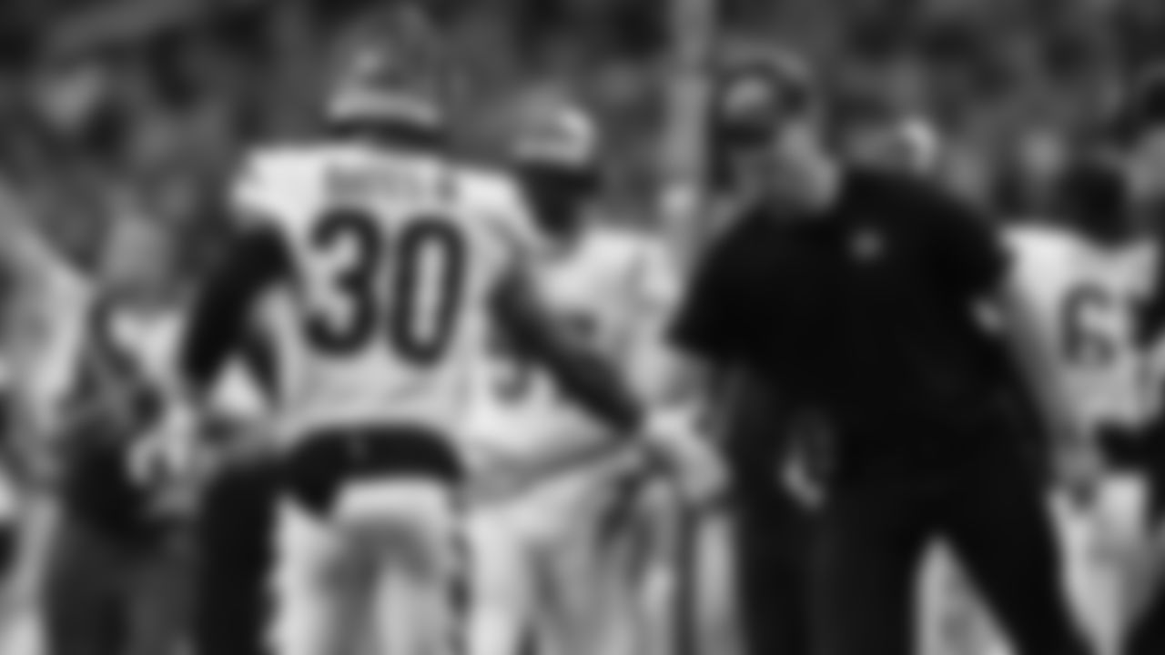 Safety Jessie Bates III is greeted by head coach Zac Taylor in a Week 6 game against the Detroit Lions.