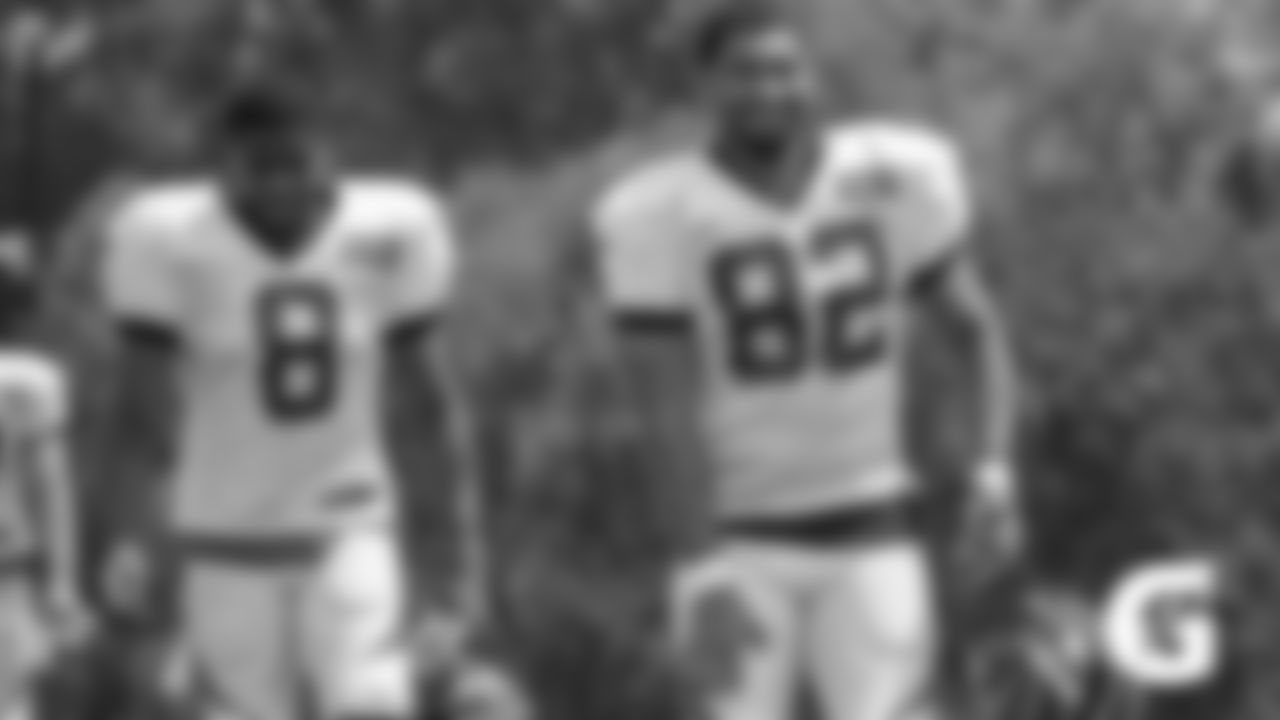 Bengals wide receiver Stanley Morgan and tight end Cethan Carter walk onto the practice field for a training camp practice.