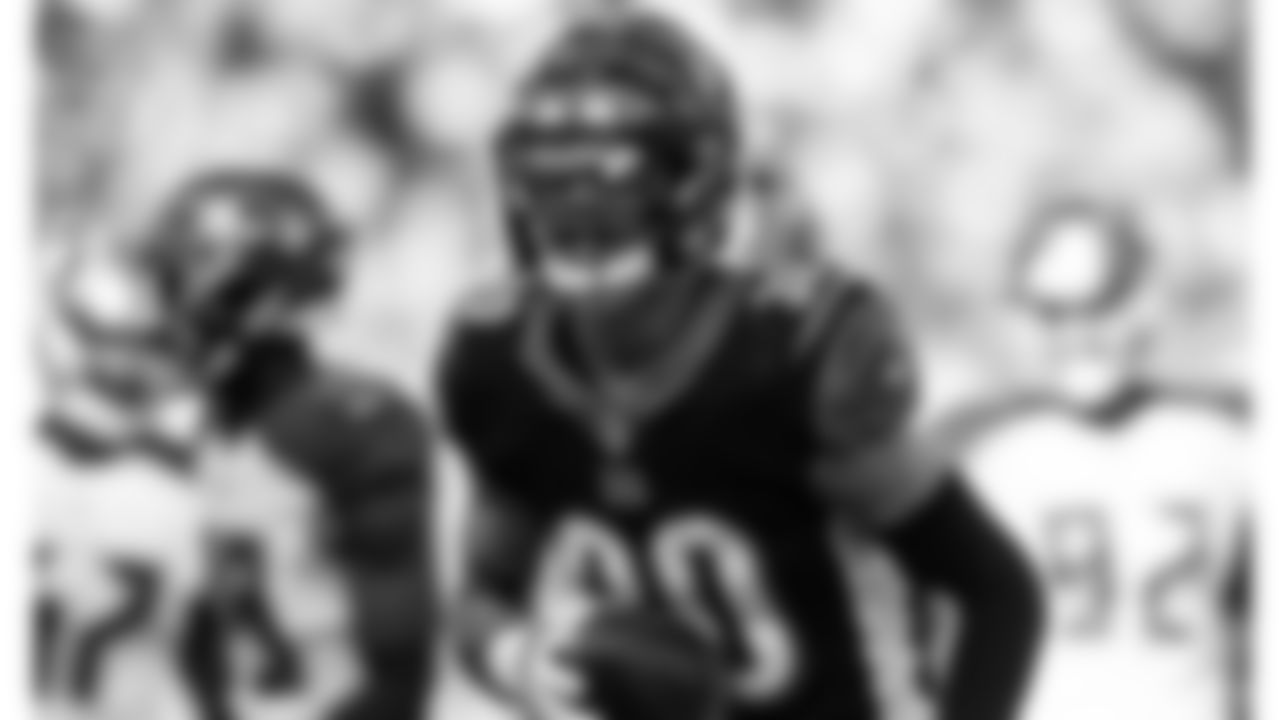 Safety Jessie Bates runs back to the sideline after returning an interception for a touchdown against the Tampa Bay Buccaneers.