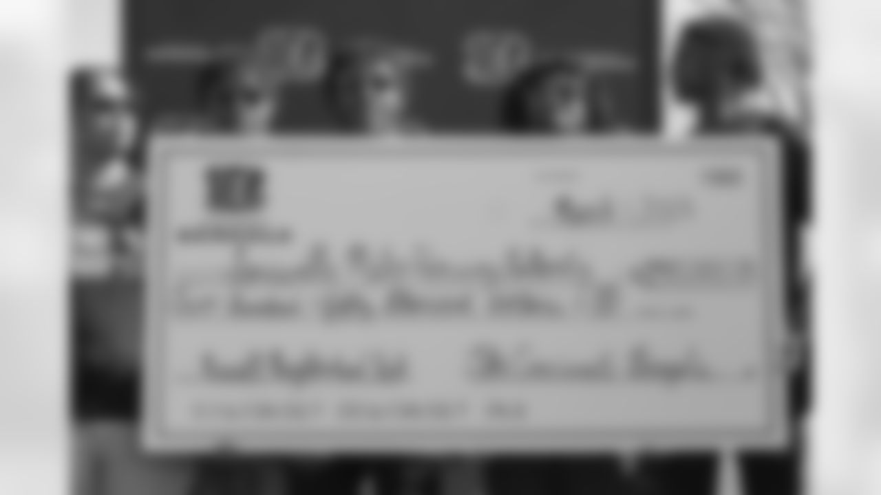Local high school football players pose with the Bengals donation after announcing Replacement Park in Louisville's Russell Neighborhood on Wednesday, March 1 2023.