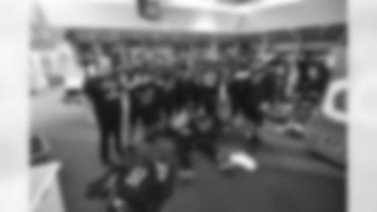 Bengals defense pose for a photo as the team celebrates winning the AFC North in the Bengals locker room at Paycor Stadium on Sunday, January 8 2023.