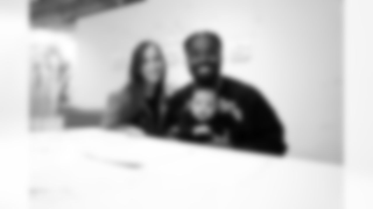 Nick Scott (right) and his wife Holly smile for the camera as Nick officially signs with the Bengals during the 2023 NFL Free Agency Period on March 20th, 2023.
