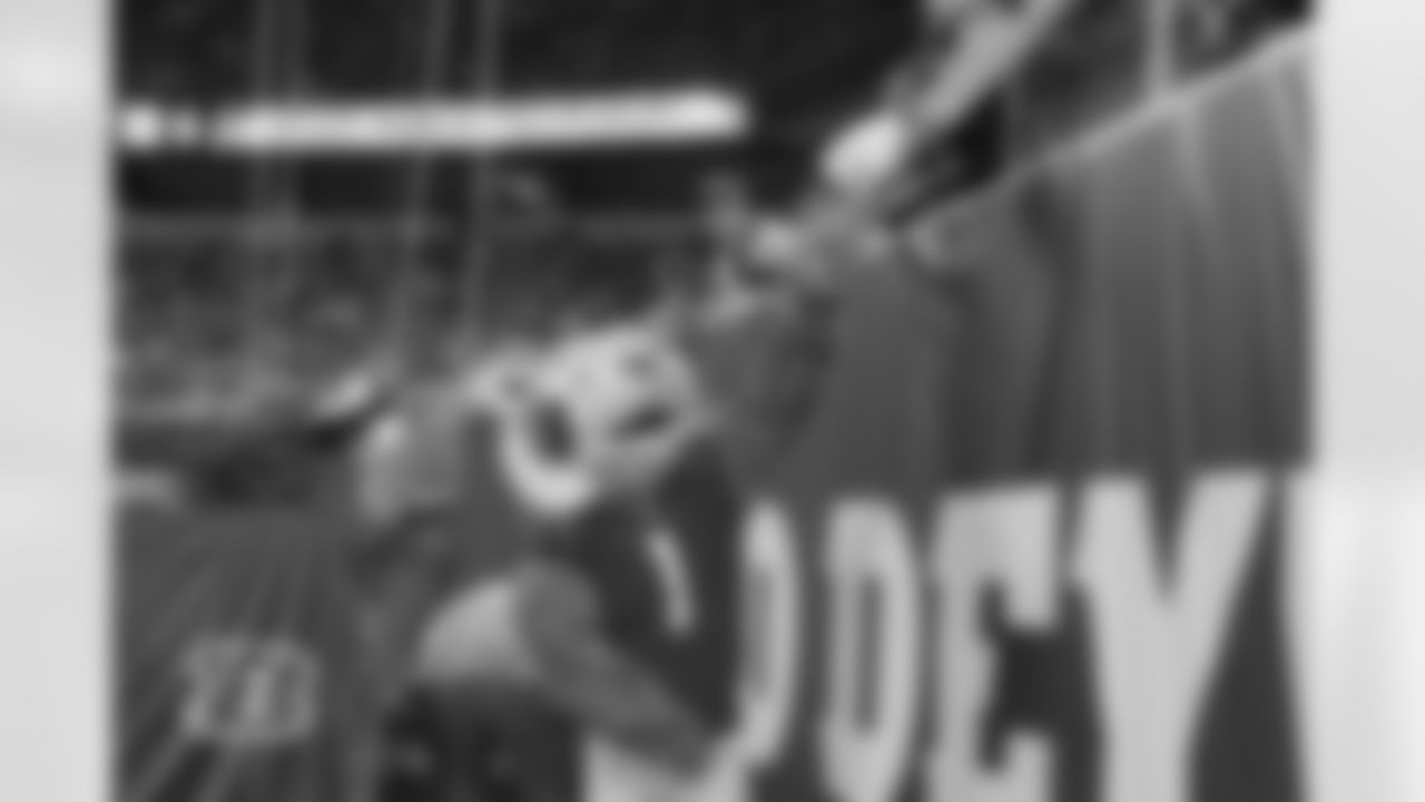 Who Dey high-fives fans at Paycor Stadium during the Packers-Bengals preseason game on Friday, August 11, 2023.